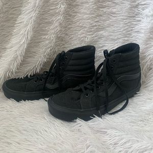 Black high top vans, with black laces.